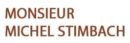 Texte en marron : "MONSIEUR MICHEL STIMBACH" sur fond blanc, typographie simple.